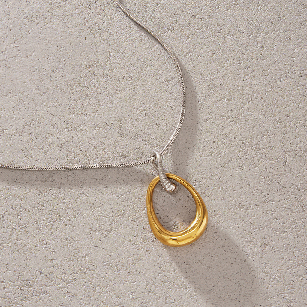 Pendant necklace arranged on a textured surface