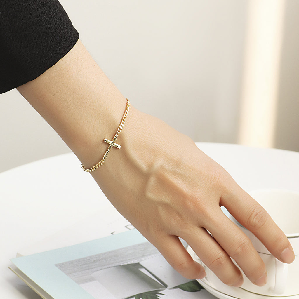 model wearing a slim cross curb chain bracelet