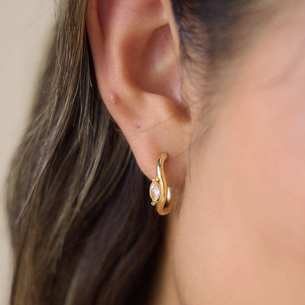 Marquise stone open hoop shown on ear from side