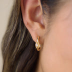 Marquise stone open hoop shown on ear from side