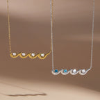 Two wave necklace color options on a display