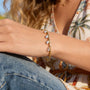 gold plated pear-drop cuff bracelet worn on wrist