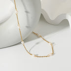 Fine gold-tone necklace showing separated freshwater pearls