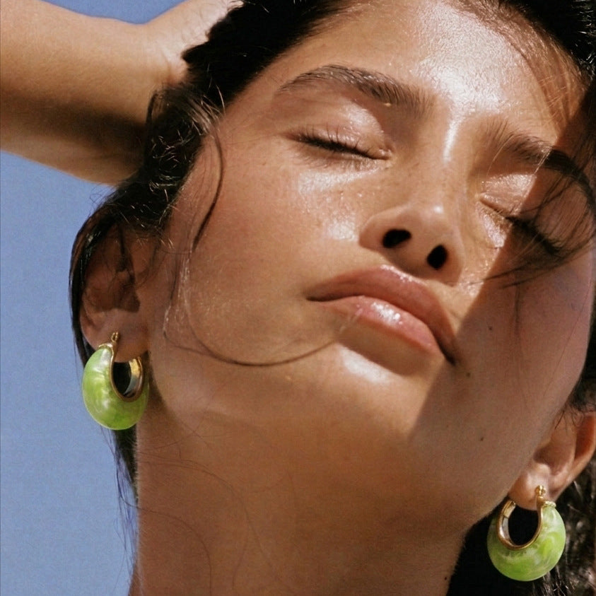 Bright green resin crescent hoops worn by model