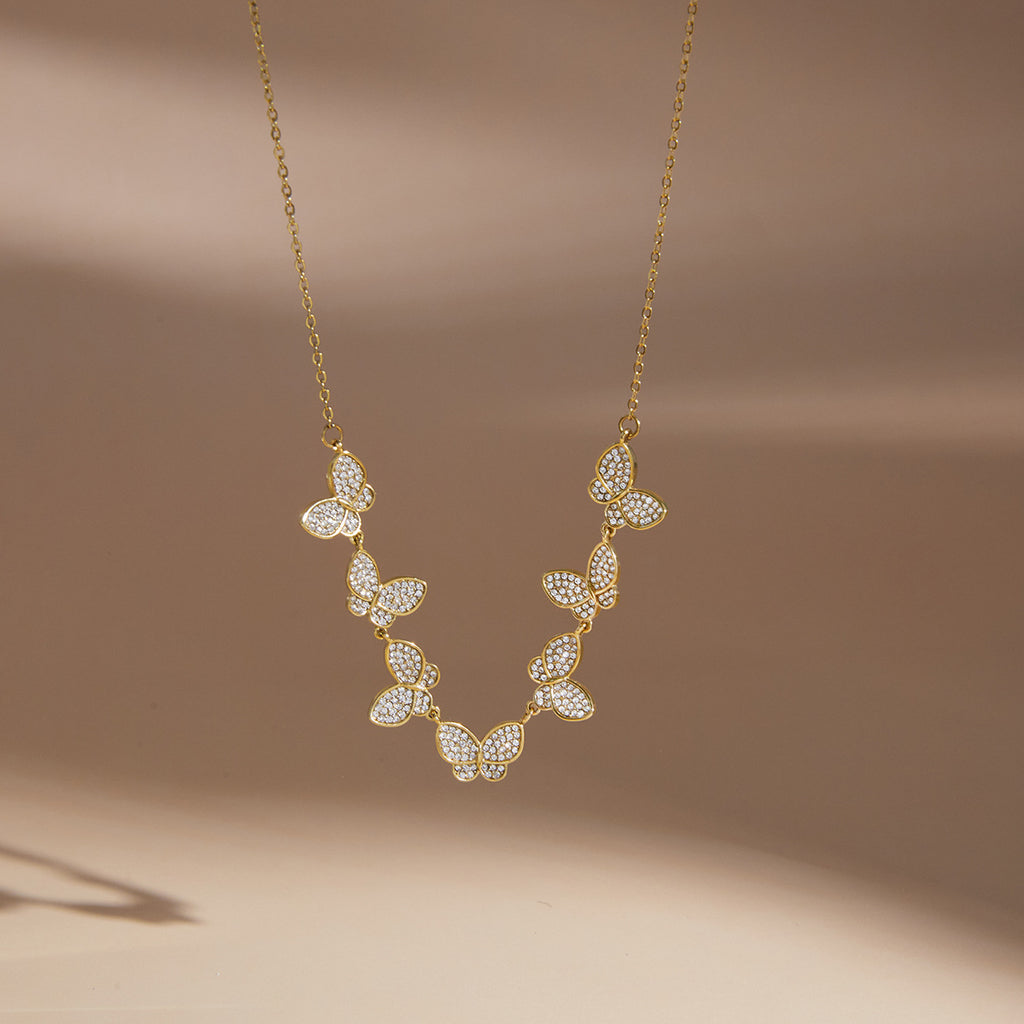 Single butterfly row necklace on a display bust