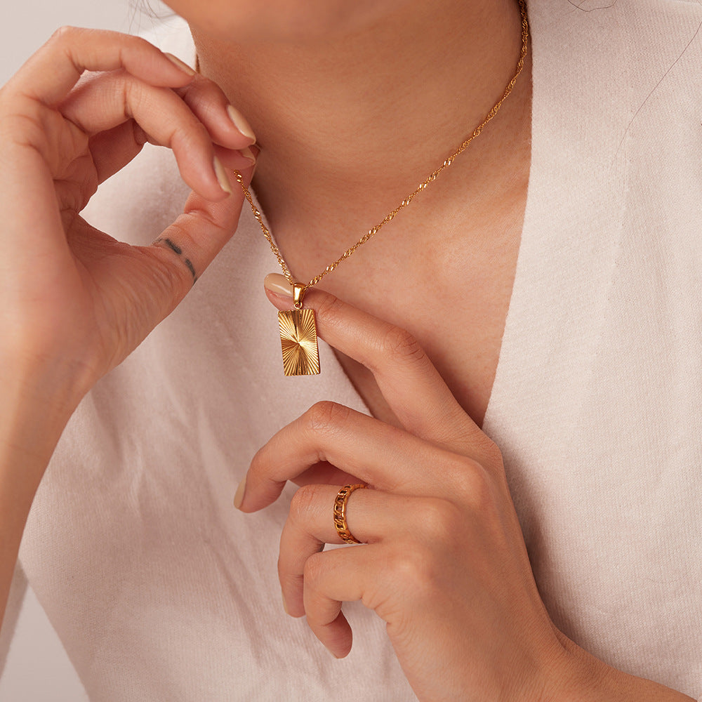 model wearing the compact gold plated rectangular pendant necklace