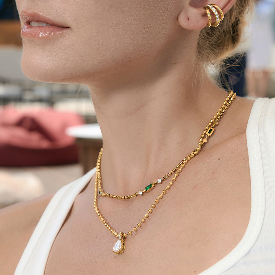 Pear pendant layered with green accent chain