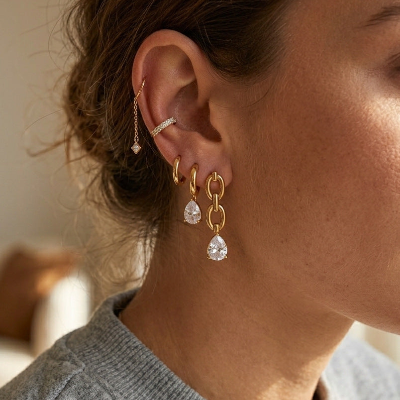 Asymmetric link drop earrings worn with reference ear jewelry