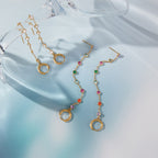clear and multicolor rhinestone tassel earring pairs on glass