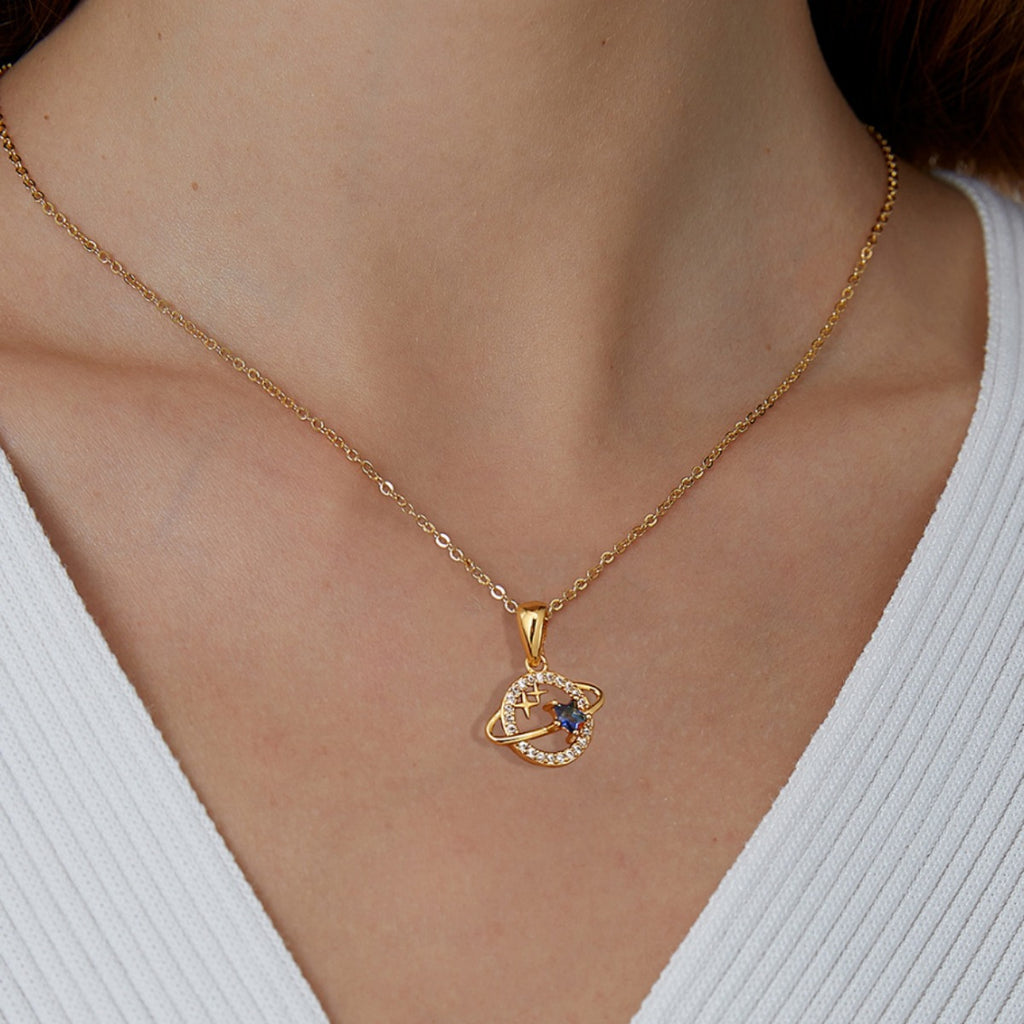 gold plated orbit planet pendant necklace worn at the collarbone