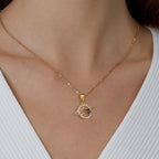 gold plated orbit planet pendant necklace worn at the collarbone