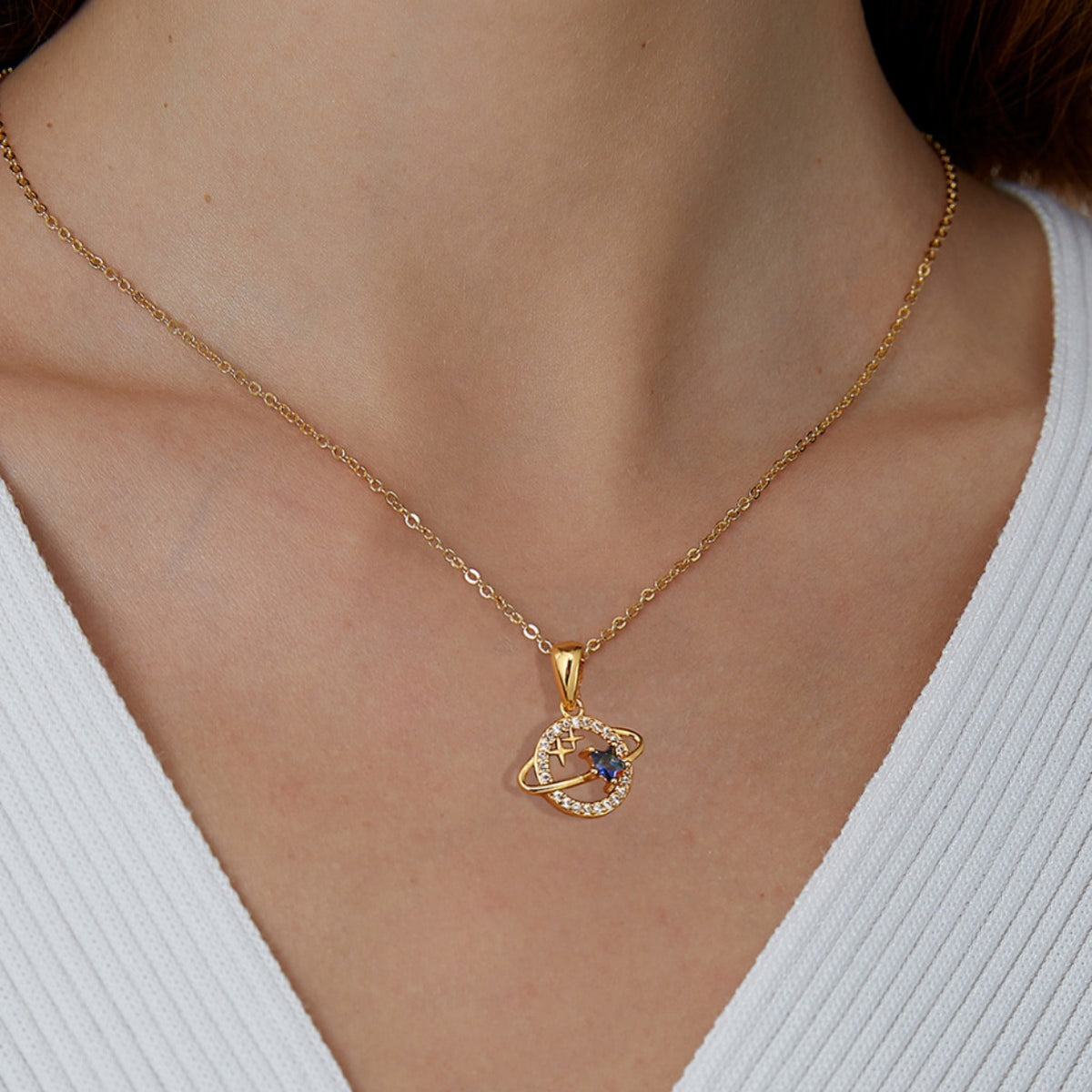 gold plated orbit planet pendant necklace worn at the collarbone