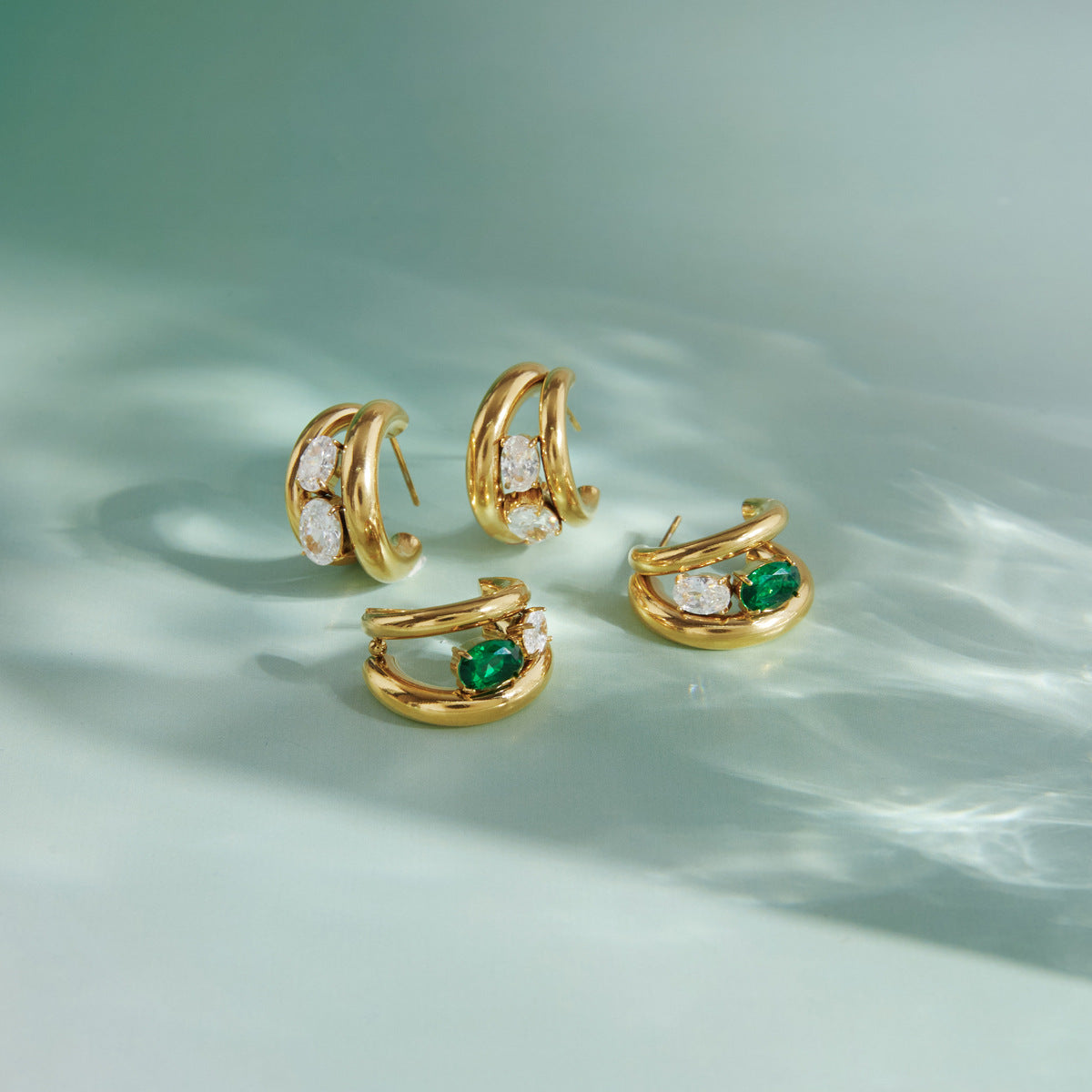 Two earring color options on pale fabric