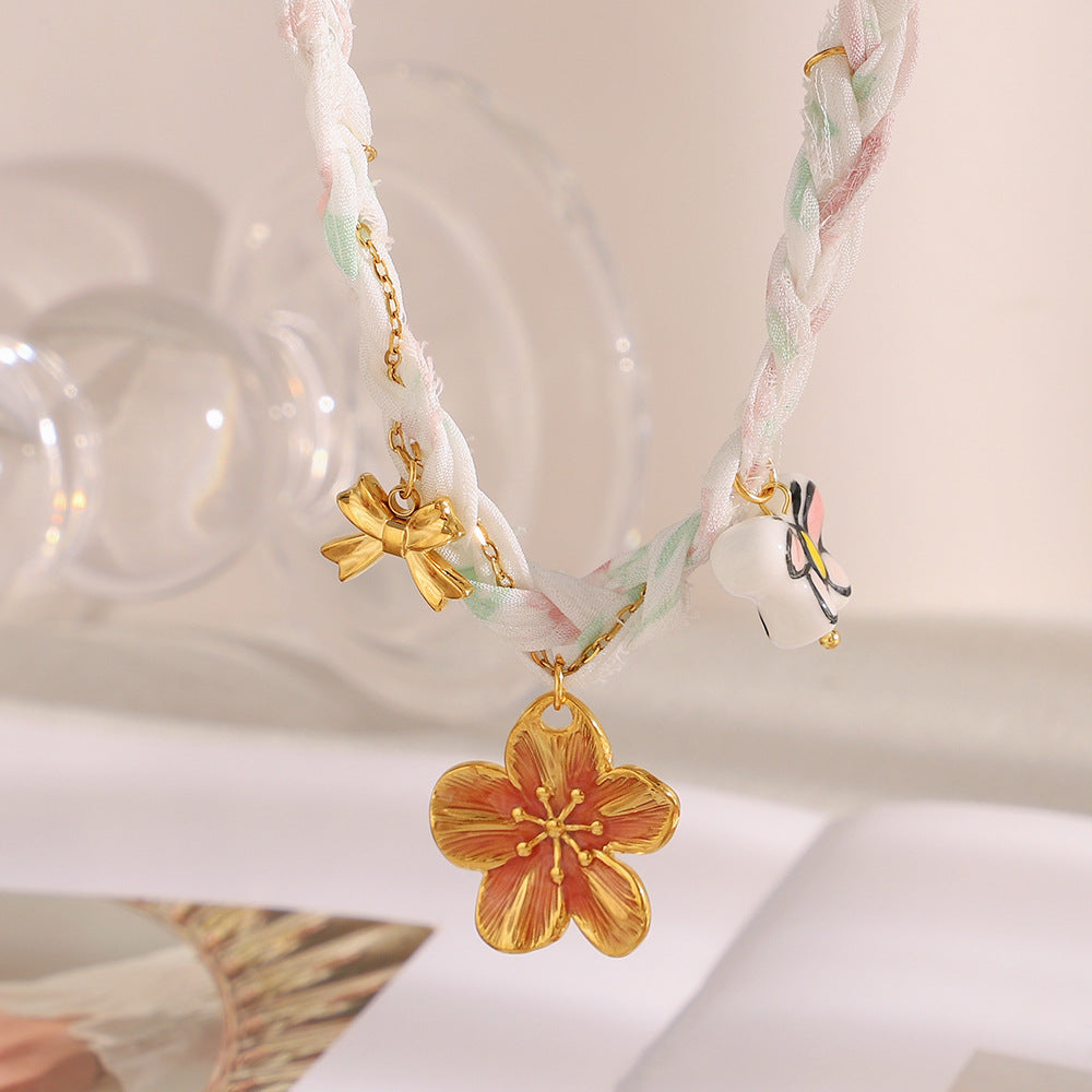 Pastel braided ribbon necklace with large flower charm