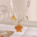 Pastel braided ribbon necklace with large flower charm