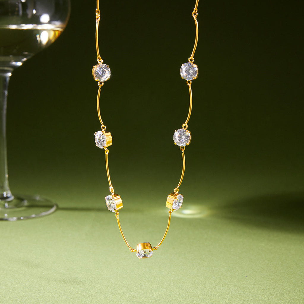 Station necklace suspended with clear round stones