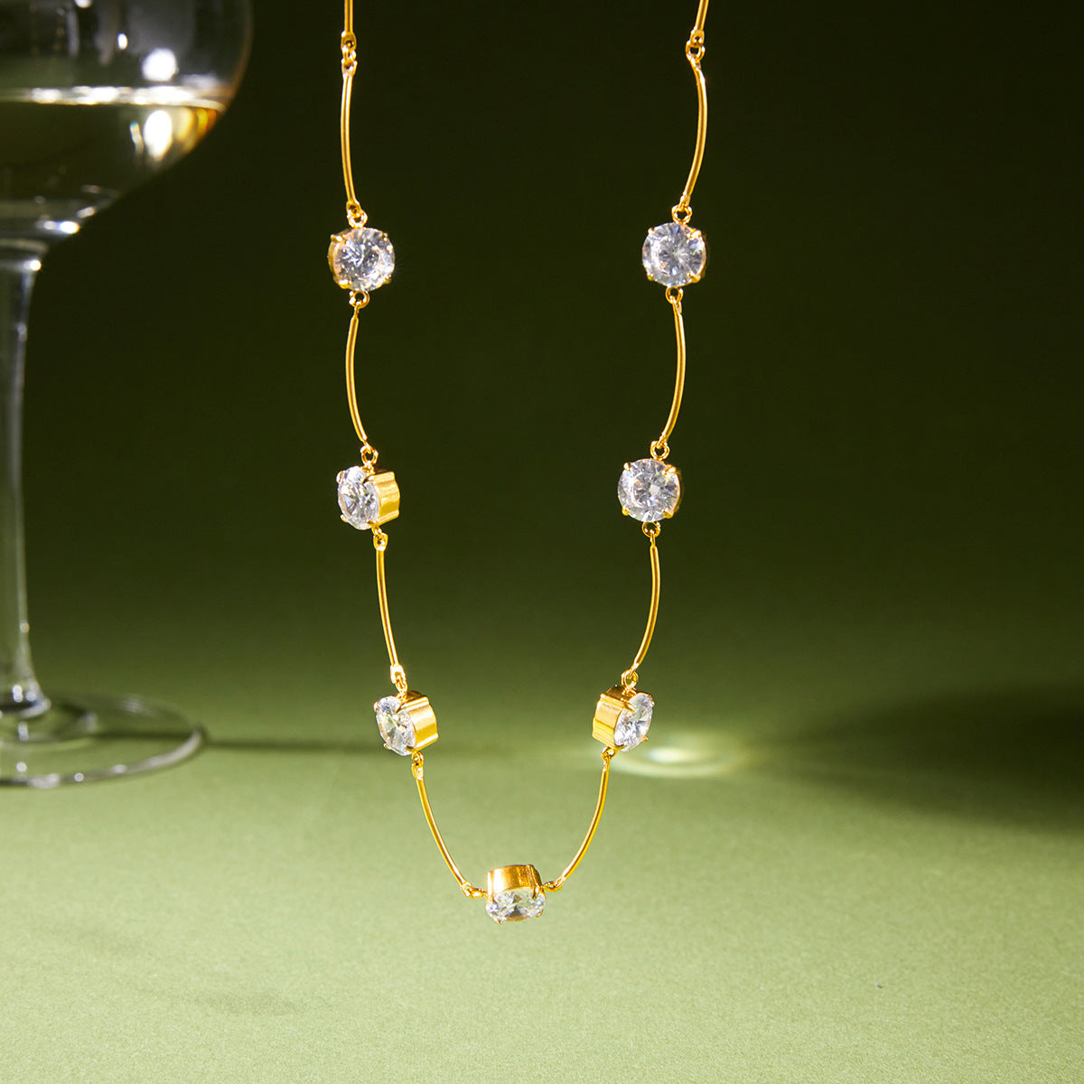 Station necklace suspended with clear round stones