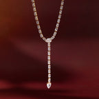 gold plated rectangular-stone Y necklace against red backdrop