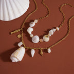 Long charm necklace and shorter shell-bead design displayed together