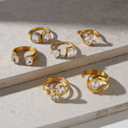 Asymmetric stainless steel ring assortment displayed on stone