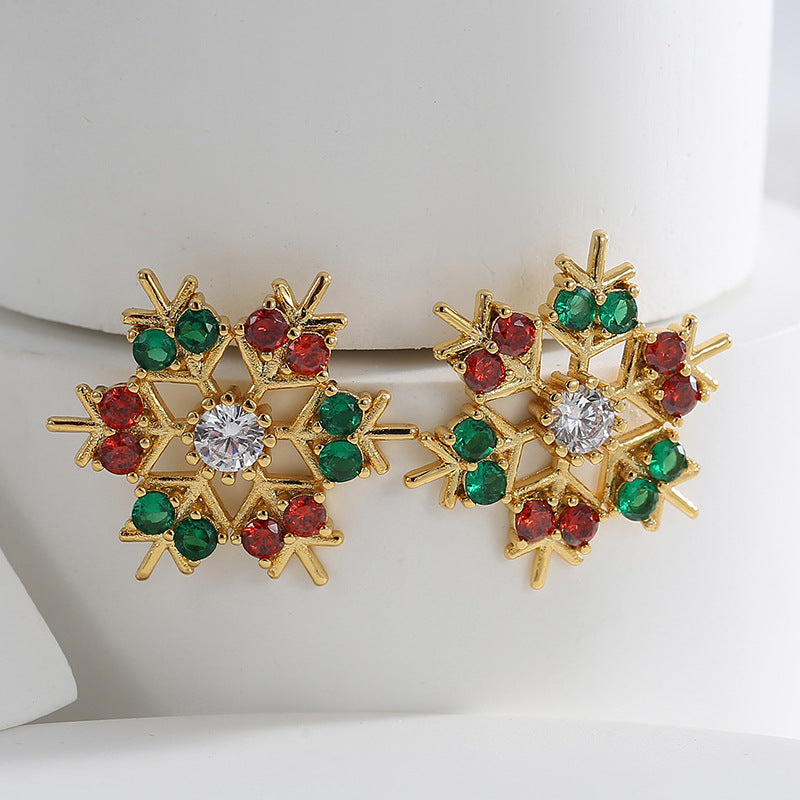 Gold plated snowflake stud earrings with alternating red and green stones