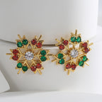Gold plated snowflake stud earrings with alternating red and green stones