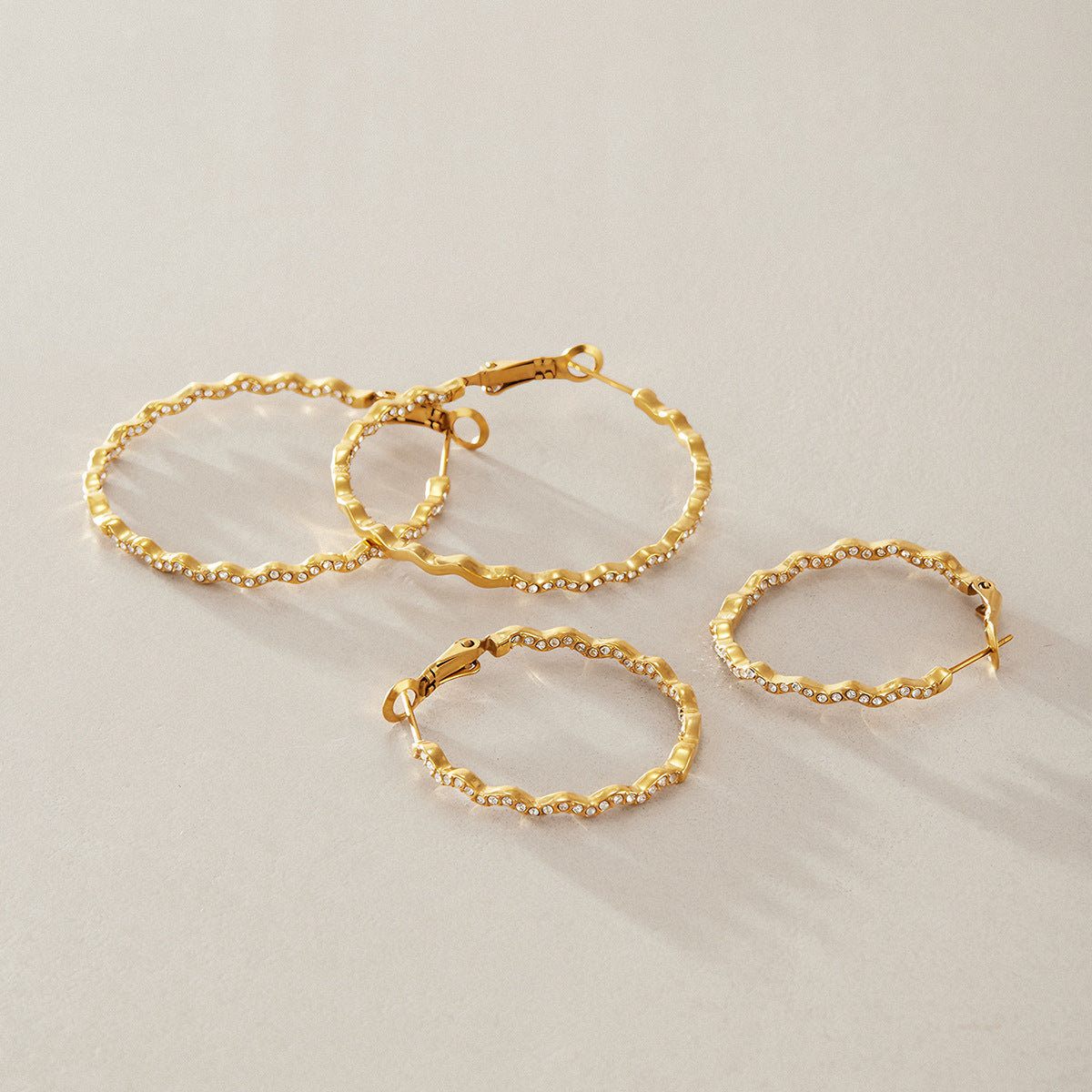 Small and large wavy hoops displayed together