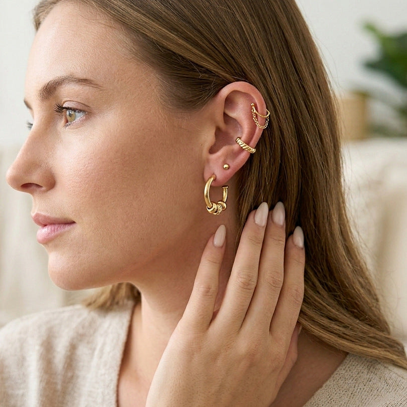 Gold-tone hoop earrings styled on a model