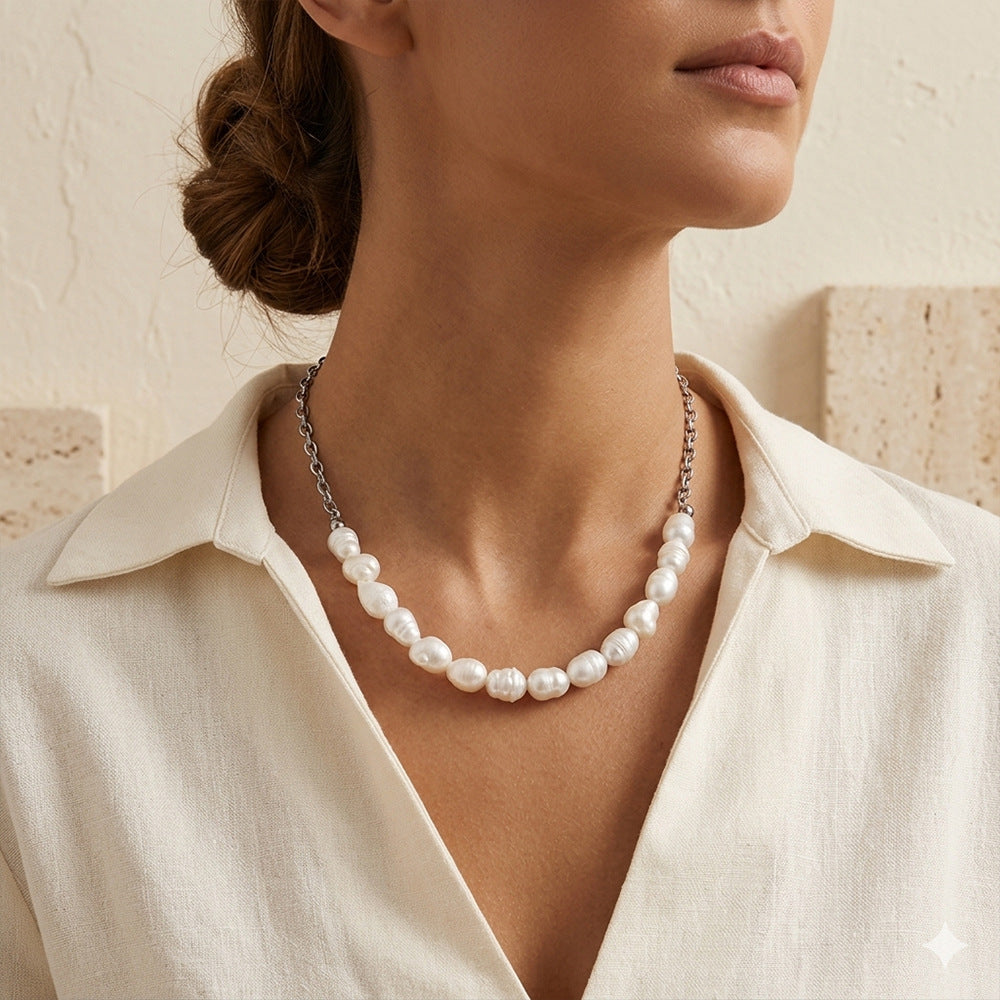 Silver-tone pearl and chain necklace worn at neckline