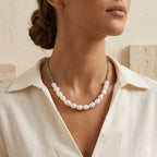Silver-tone pearl and chain necklace worn at neckline