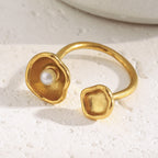 gold plated stainless steel open ring with sculpted shell cups and pearl