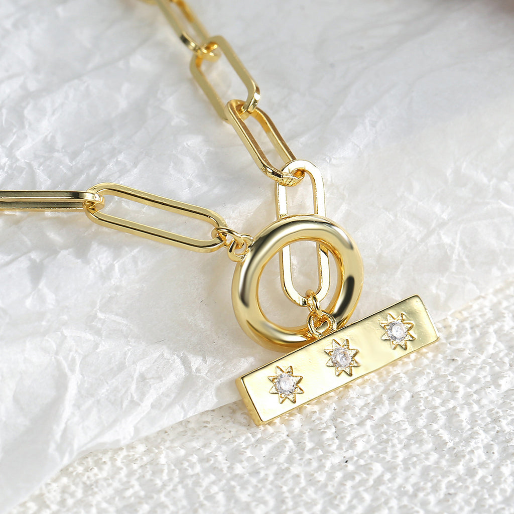 close view of the round toggle and three-zirconia bar pendant
