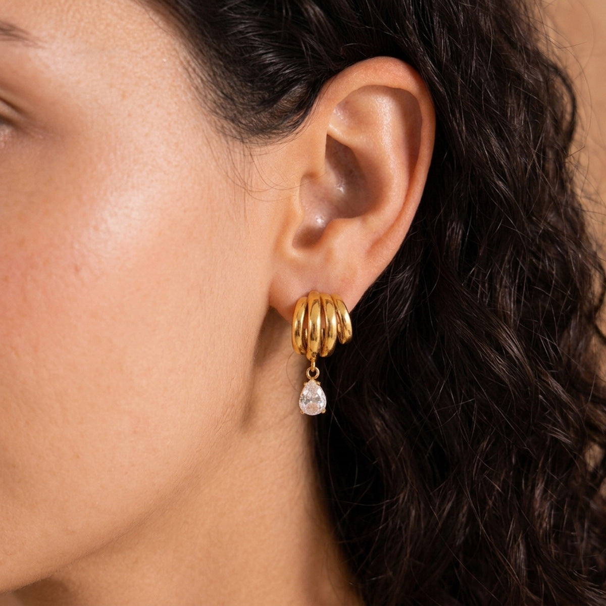 Layered curved loops and dangling stone shown in profile