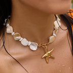 Shell bead necklace with large gold tone starfish worn on model