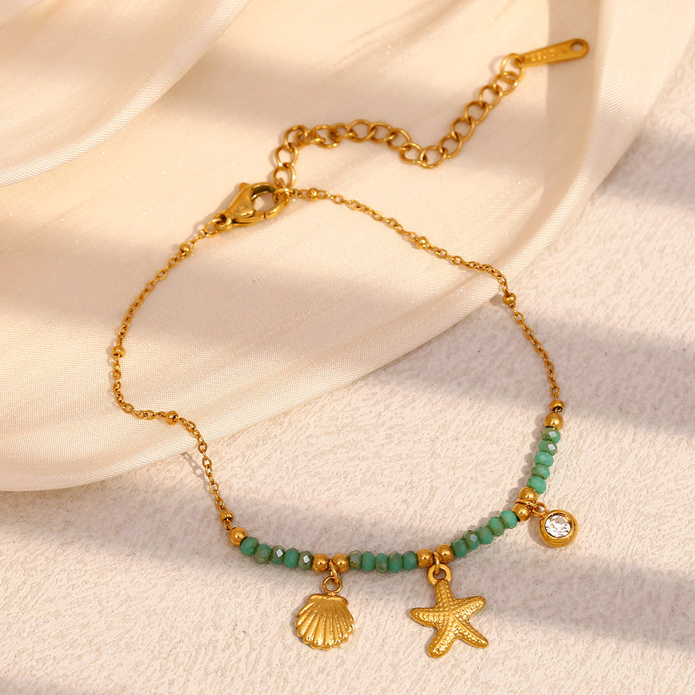 Gold Plated Stainless Steel Green Bead Starfish and Shell Bracelet — worn view