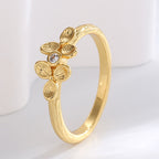 angled textured four-petal clover ring on pale display