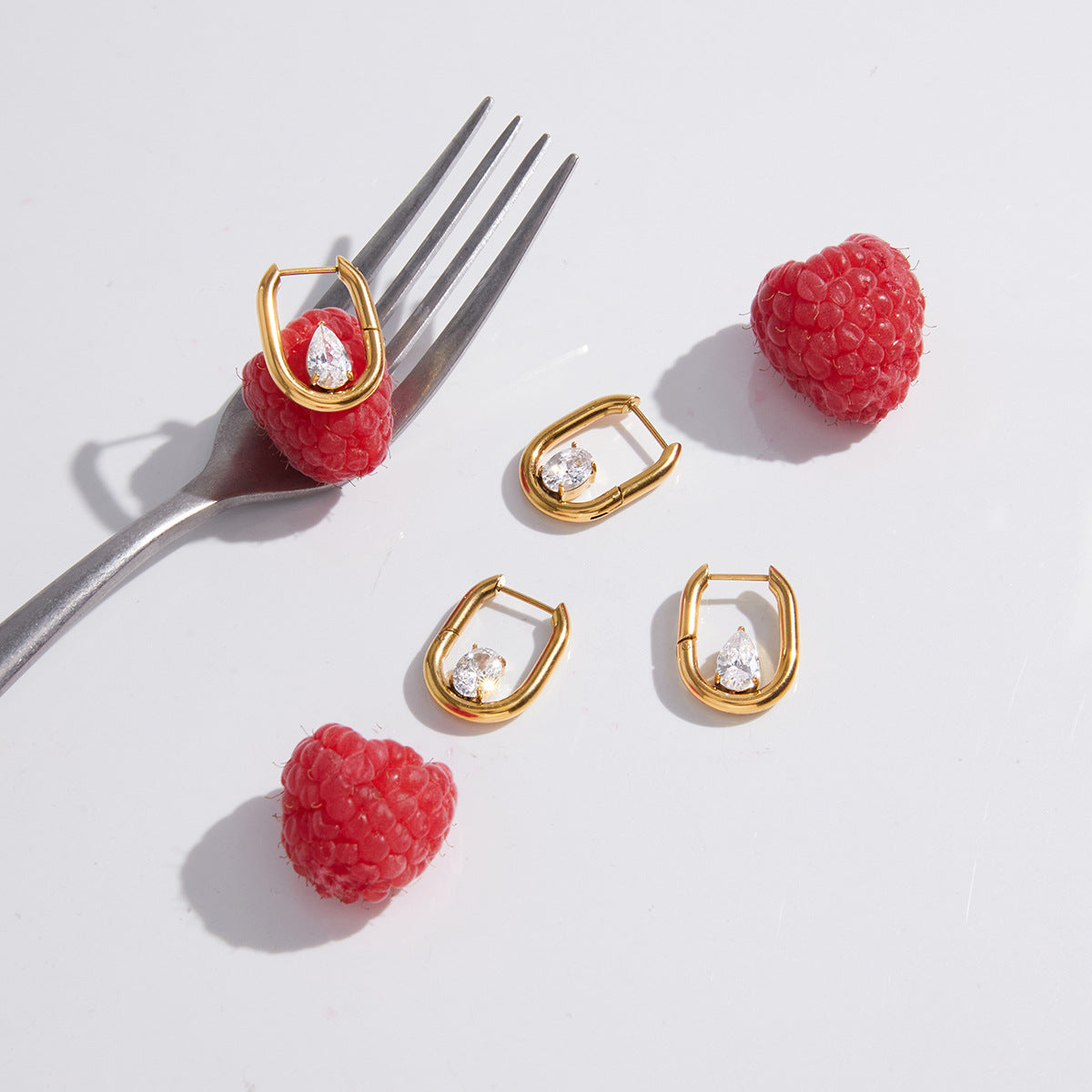U-shaped stone hoops displayed with raspberries