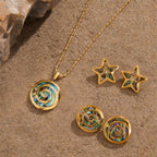 Spiral and star jewelry displayed on sand