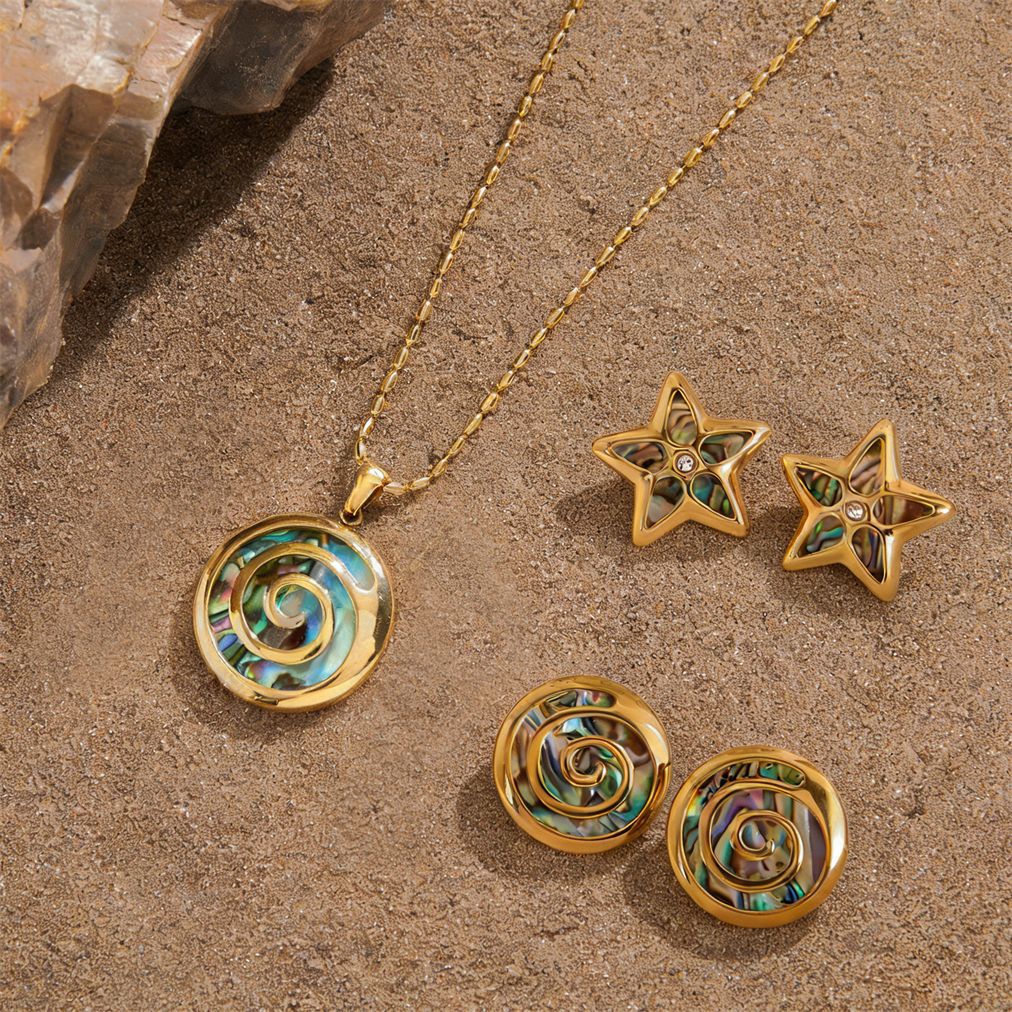 Spiral and star jewelry displayed on sand