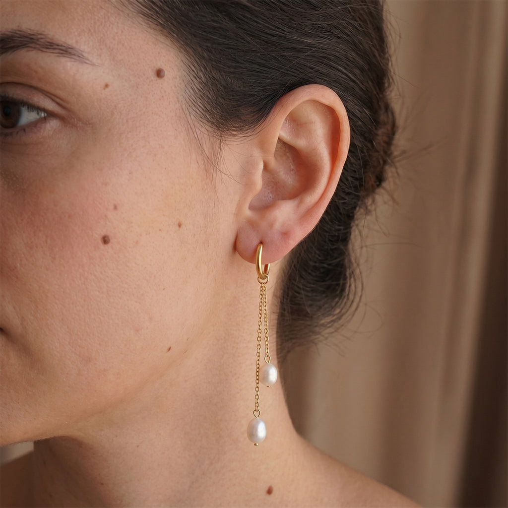 Double-chain white-drop hoop shown on the ear