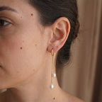 Double-chain white-drop hoop shown on the ear