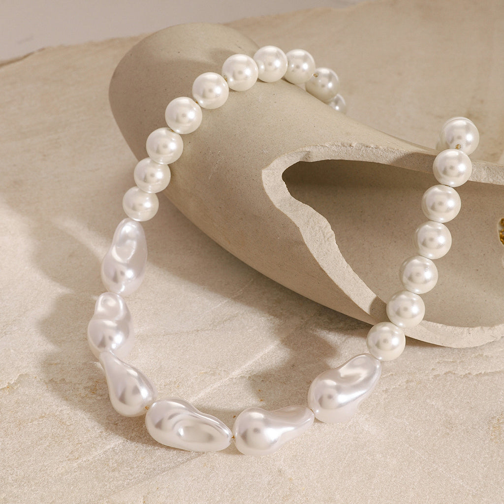 White round and irregular bead necklace on a sculptural display