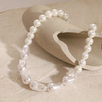 White round and irregular bead necklace on a sculptural display