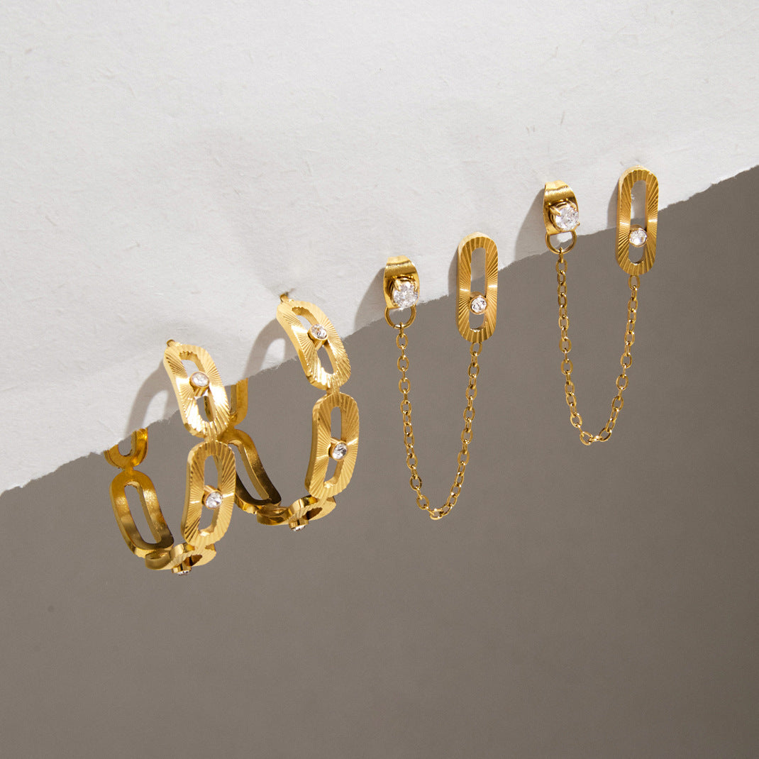 Textured link open hoops and chain earrings on stone