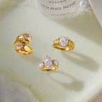 Three gold tone ring styles displayed on a tray