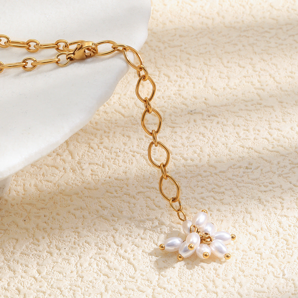 Close-up of the white faux pearl flower and diamond-shaped chain links