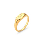 Oval gold tone signet with engraved text
