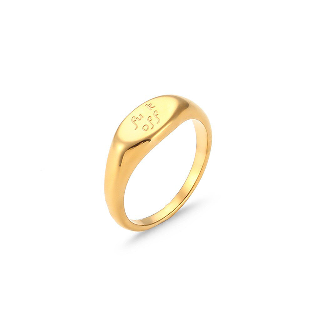 Oval gold tone signet with engraved text