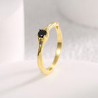 angled view of round black stone and waved ring shoulders