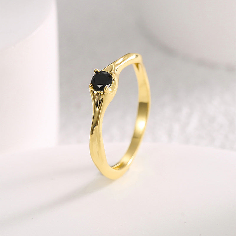 angled view of round black stone and waved ring shoulders